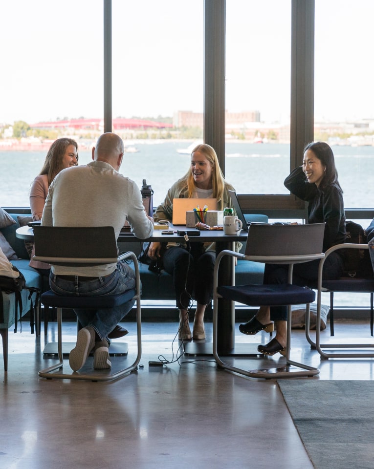 Employees at desk talking
