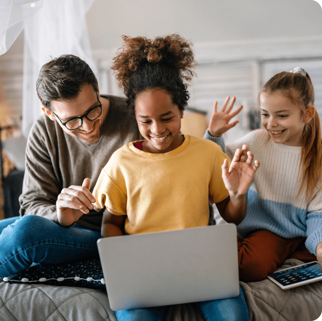 Joyous family using laptop to make video call.