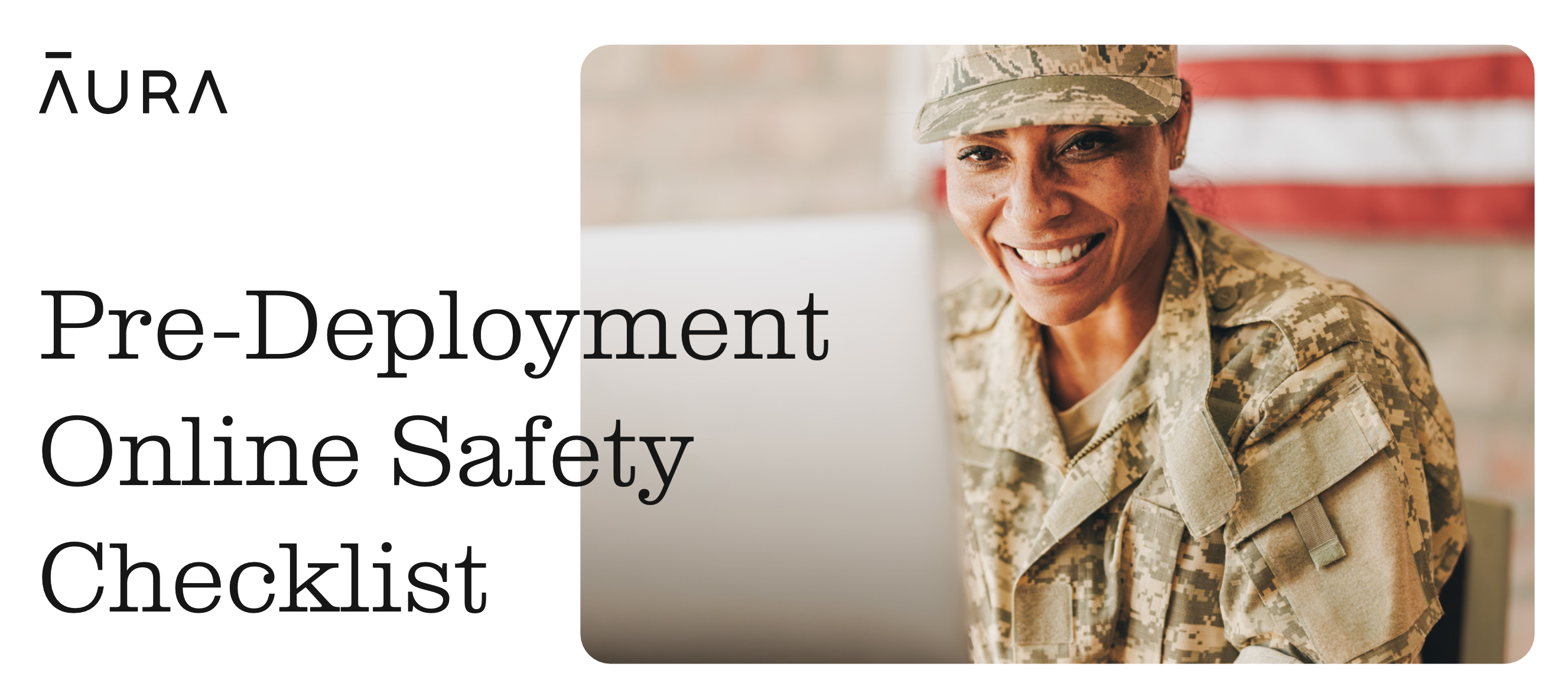 A woman in military uniform looking at a computer and smiling.