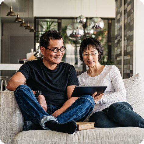 Couple on couch with tablet